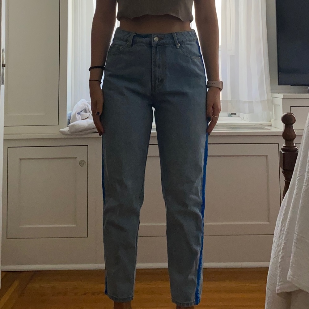 Light wash jeans with royal blue velvet stripe on the sides, from Adika